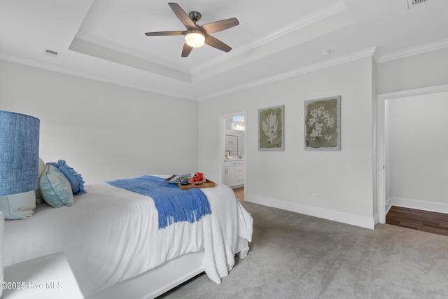 57 N Passerine Path, Hampstead, NC 28443 - bedroom featuring a raised ceiling, crown molding, carpet flooring, a ceiling fan, and ensuite bath
