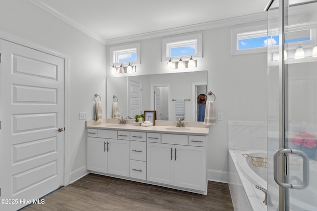 57 N Passerine Path, Hampstead, NC 28443 - full bathroom featuring double vanity, a garden tub, crown molding, a stall shower, and wood finished floors