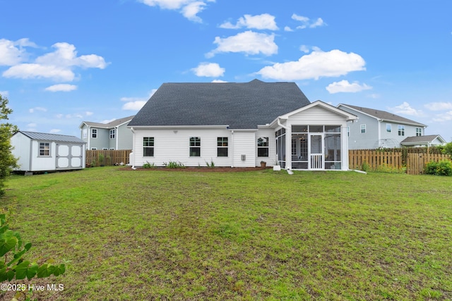 57 N Passerine Path, Hampstead, NC 28443 - back of property featuring a sunroom, a storage shed, a fenced backyard, and a shingled roof