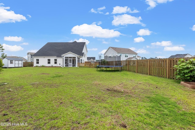 57 N Passerine Path, Hampstead, NC 28443 - fenced backyard with a shed, a trampoline, and a sunroom