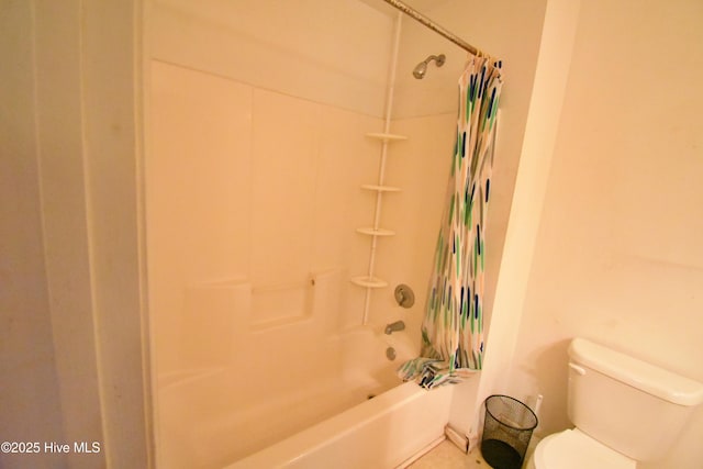 bathroom featuring shower / tub combo with curtain and toilet