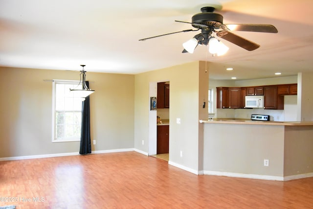 unfurnished living room featuring light wood-type flooring, baseboards, recessed lighting, and ceiling fan