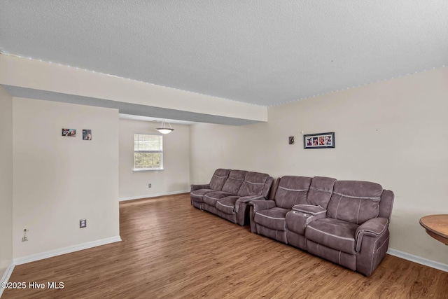 213 Spruce Ct, Jacksonville, NC 28546 - living room with wood finished floors, baseboards, and a textured ceiling