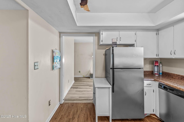 213 Spruce Ct, Jacksonville, NC 28546 - kitchen with stainless steel appliances, white cabinetry, wood finished floors, and baseboards