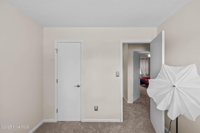 213 Spruce Ct, Jacksonville, NC 28546 - unfurnished bedroom with carpet flooring, baseboards, and a textured ceiling