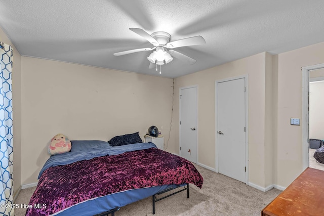 213 Spruce Ct, Jacksonville, NC 28546 - bedroom with carpet flooring, a textured ceiling, a ceiling fan, and baseboards