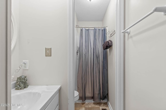 213 Spruce Ct, Jacksonville, NC 28546 - bathroom featuring vanity, a shower with shower curtain, toilet, and a textured ceiling