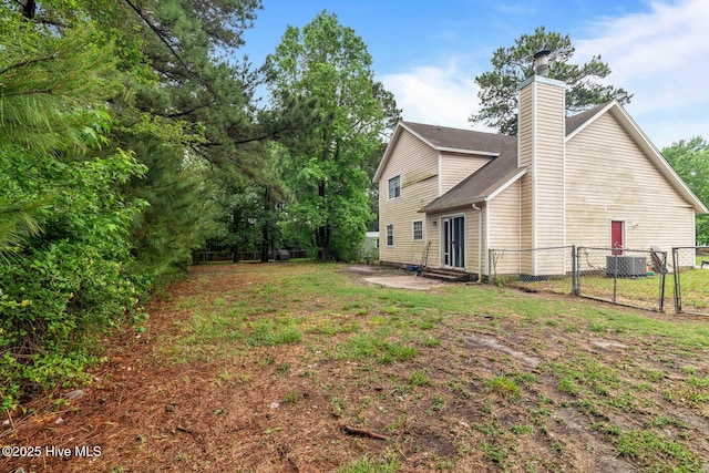 213 Spruce Ct, Jacksonville, NC 28546 - rear view of property featuring a gate, entry steps, a chimney, and central AC unit