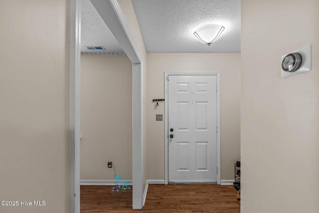 213 Spruce Ct, Jacksonville, NC 28546 - doorway to outside with a textured ceiling, wood finished floors, and baseboards