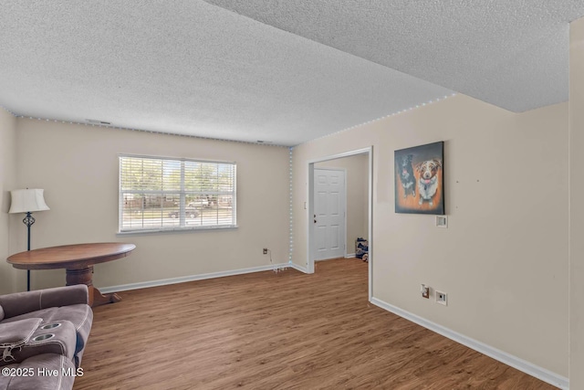 213 Spruce Ct, Jacksonville, NC 28546 - unfurnished room with a textured ceiling, wood finished floors, and baseboards
