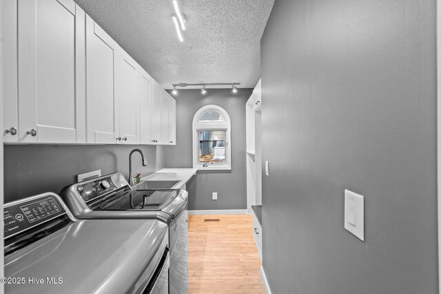 kitchen with a textured ceiling, dark countertops, a barn door, ornamental molding, and stainless steel appliances