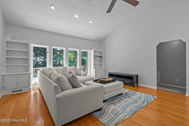 living area with recessed lighting, ceiling fan, light wood finished floors, and high vaulted ceiling