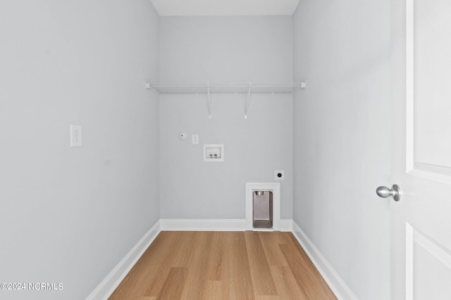 laundry room featuring hookup for an electric dryer, light wood-type flooring, baseboards, washer hookup, and laundry area