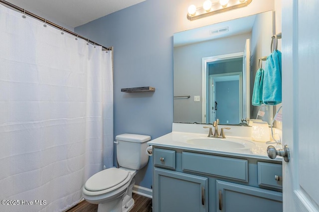 full bath featuring visible vents, wood finished floors, toilet, and vanity