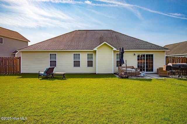 rear view of house featuring outdoor lounge area, fence, roof with shingles, a patio area, and a lawn
