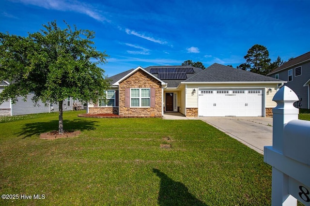 view of front of property featuring a front yard, stone siding, an attached garage, driveway, and solar panels