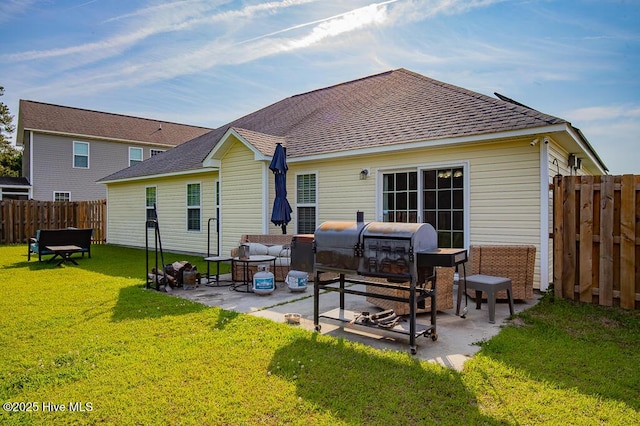 back of house with a shingled roof, an outdoor hangout area, a fenced backyard, a patio area, and a yard