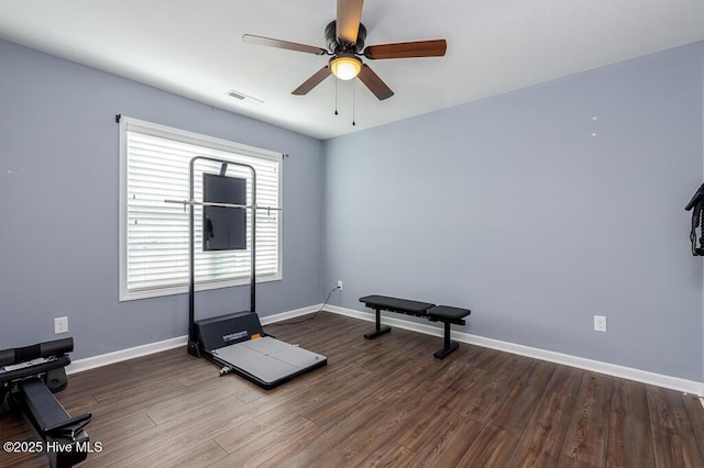 workout room featuring a ceiling fan, baseboards, visible vents, and wood finished floors