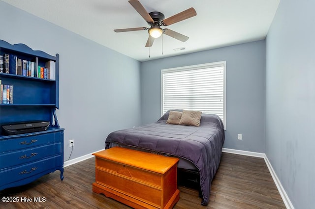 bedroom featuring ceiling fan, baseboards, visible vents, and wood finished floors