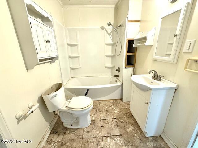 full bath with vanity, baseboards, crown molding, toilet, and shower / bathtub combination