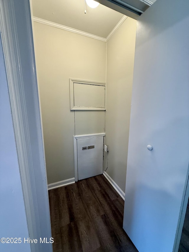 laundry room with ornamental molding, baseboards, and dark wood finished floors