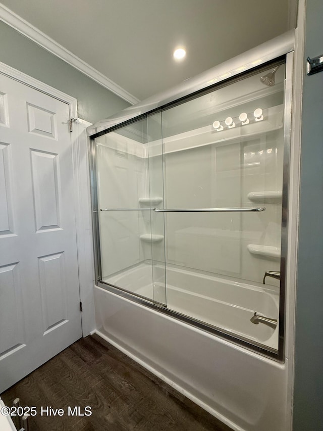 bathroom with recessed lighting, crown molding, enclosed tub / shower combo, and wood finished floors