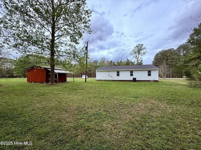 rear view of property with an outbuilding, crawl space, and a lawn