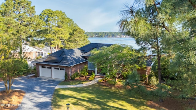 120 Clay Cir W, End, NC 27376 - view of front of property with a water view, a garage, brick siding, a front yard, and aphalt driveway