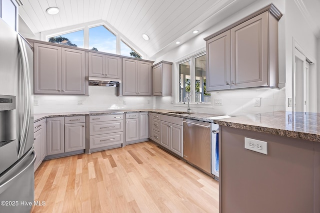 120 Clay Cir W, End, NC 27376 - kitchen with under cabinet range hood, vaulted ceiling, gray cabinets, a sink, and appliances with stainless steel finishes