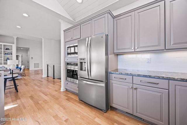 120 Clay Cir W, End, NC 27376 - kitchen featuring lofted ceiling, stainless steel appliances, visible vents, gray cabinets, and tasteful backsplash