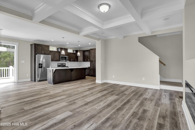 101 SE 68th St, Oak Island, NC 28465 - unfurnished living room featuring baseboards, beam ceiling, and coffered ceiling