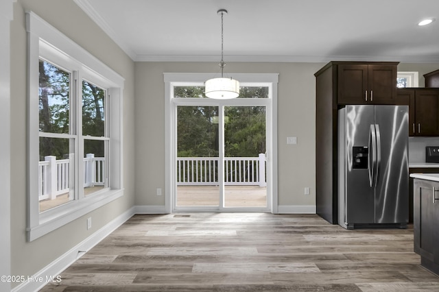 101 SE 68th St, Oak Island, NC 28465 - kitchen featuring crown molding, light wood finished floors, stainless steel refrigerator with ice dispenser, and dark brown cabinetry