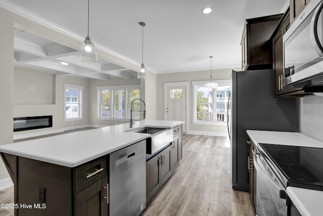 101 SE 68th St, Oak Island, NC 28465 - kitchen with recessed lighting, plenty of natural light, light wood-style flooring, stainless steel appliances, and a sink