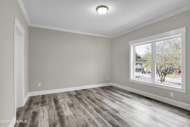 101 SE 68th St, Oak Island, NC 28465 - spare room with wood finished floors, baseboards, and ornamental molding
