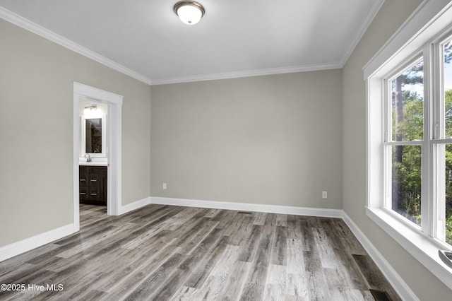101 SE 68th St, Oak Island, NC 28465 - empty room with wood finished floors, ornamental molding, and plenty of natural light