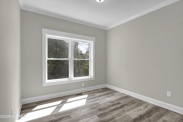 101 SE 68th St, Oak Island, NC 28465 - unfurnished room with visible vents, baseboards, crown molding, and wood finished floors