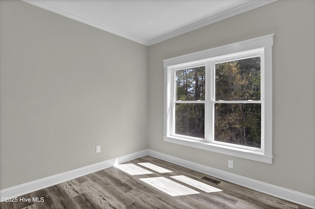 101 SE 68th St, Oak Island, NC 28465 - unfurnished room with visible vents, baseboards, crown molding, and wood finished floors
