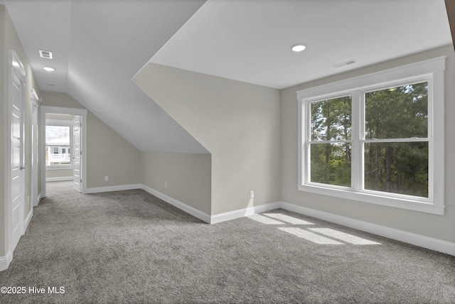 101 SE 68th St, Oak Island, NC 28465 - additional living space featuring carpet floors, baseboards, visible vents, and lofted ceiling