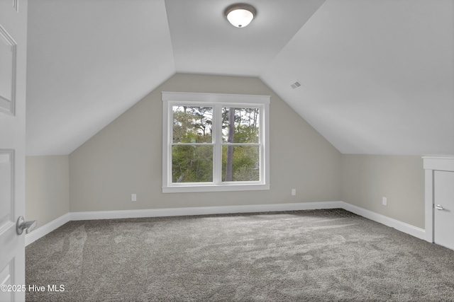 101 SE 68th St, Oak Island, NC 28465 - additional living space with visible vents, baseboards, vaulted ceiling, and carpet floors