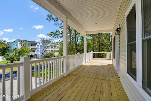 101 SE 68th St, Oak Island, NC 28465 - wooden terrace with a porch and a residential view