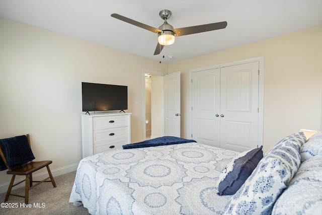 bedroom featuring a closet, light colored carpet, baseboards, and ceiling fan