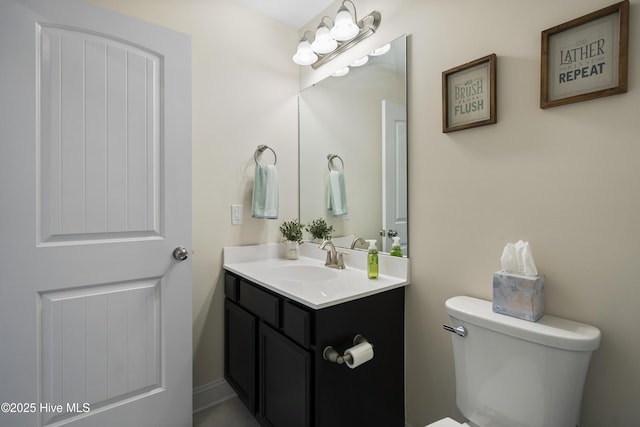 half bathroom with toilet and vanity
