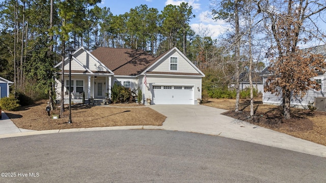 view of front facade with concrete driveway and a porch