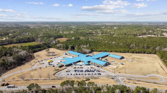 drone / aerial view with a wooded view