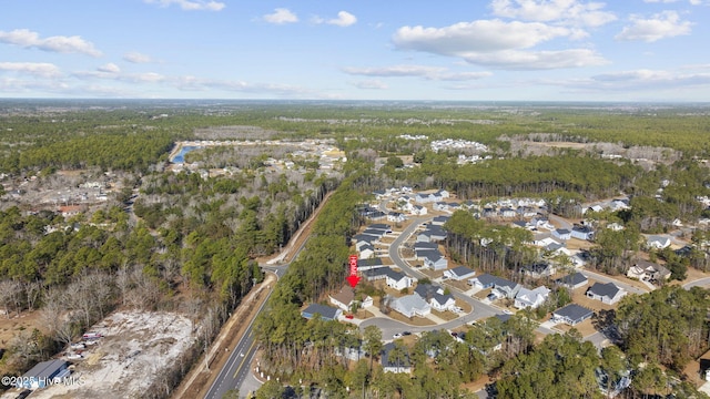 birds eye view of property with a view of trees