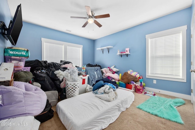 carpeted bedroom with baseboards and a ceiling fan
