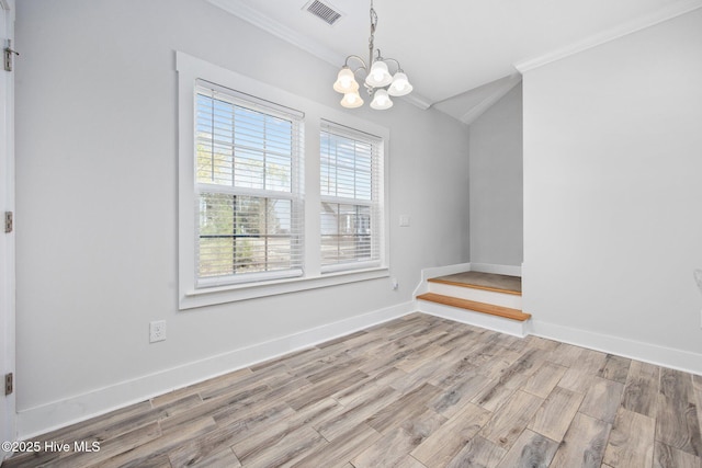 unfurnished dining area with visible vents, ornamental molding, a notable chandelier, and vaulted ceiling