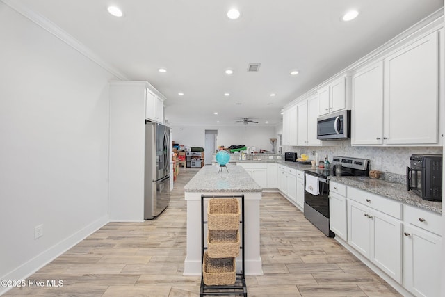 kitchen with visible vents, a peninsula, appliances with stainless steel finishes, and recessed lighting