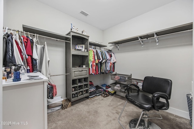 walk in closet with visible vents and light carpet