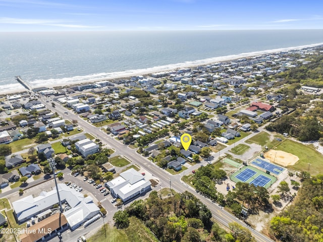 aerial view featuring a water view, a beach view, and a residential view